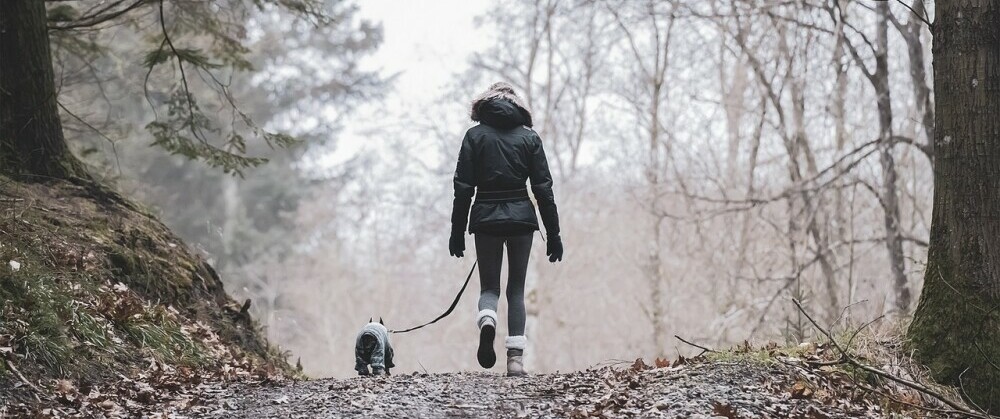Hiking with dog on leash in the winter
