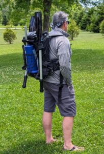 Man wearing Sevylor QuikPak K1 inflatable kayak in backpack mode